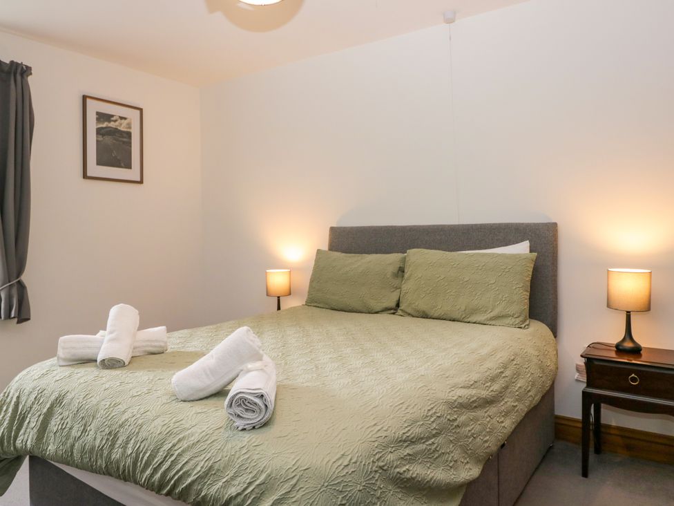 A bedroom with a bed and bedside lamps at Sherriff in Troutbeck, near Keswick