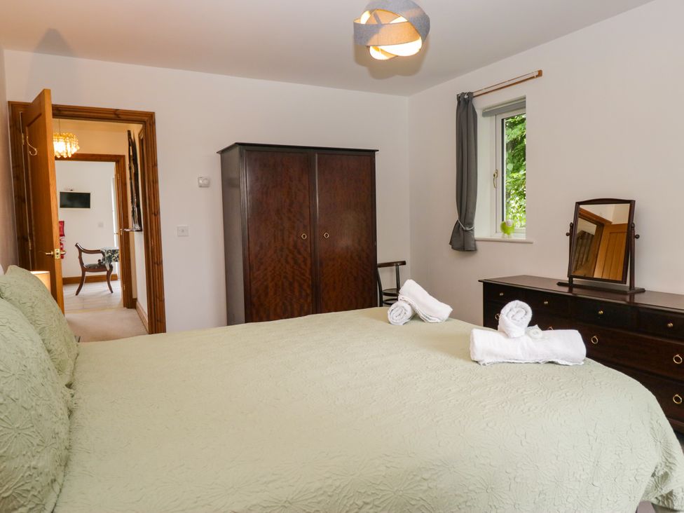 A bedroom with a bed and dresser at Sherriff in Troutbeck, near Keswick