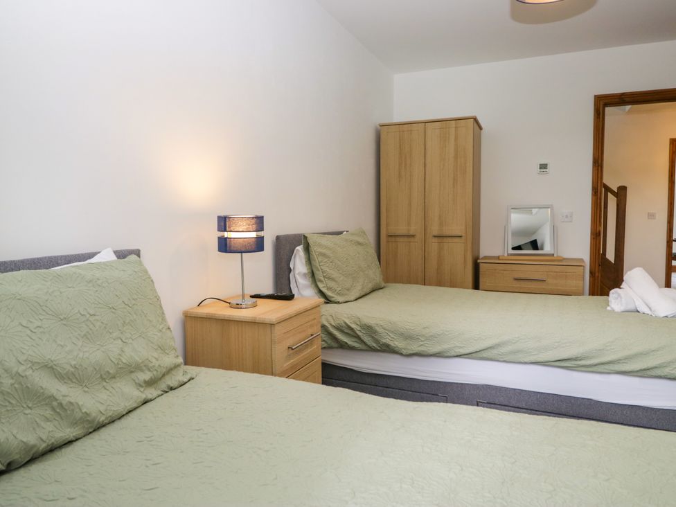 A bedroom with two beds and furniture at Sherriff near Keswick