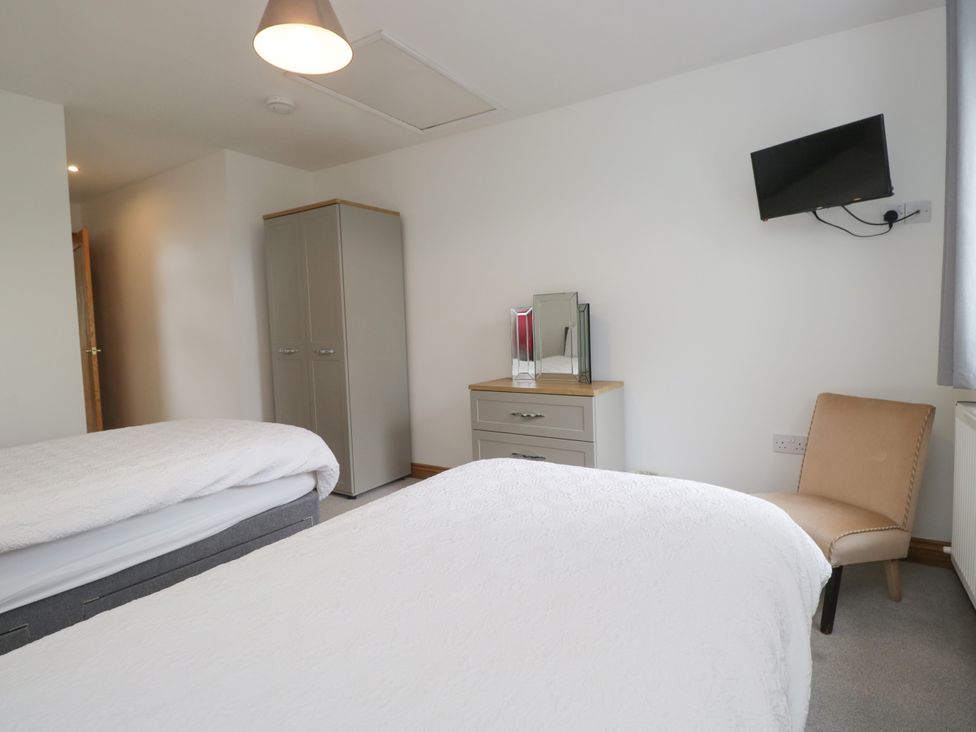 A bedroom with two beds and a television at Sherriff, Troutbeck, near Keswick