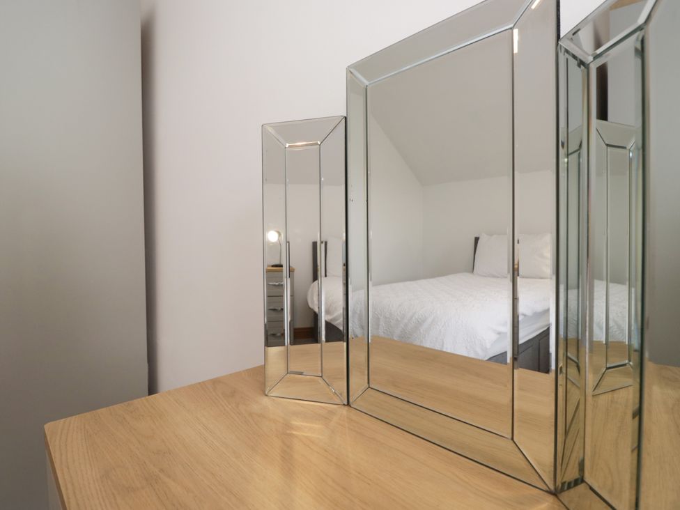 A bedroom with mirrors and a bed at Sherriff in Troutbeck, near Keswick