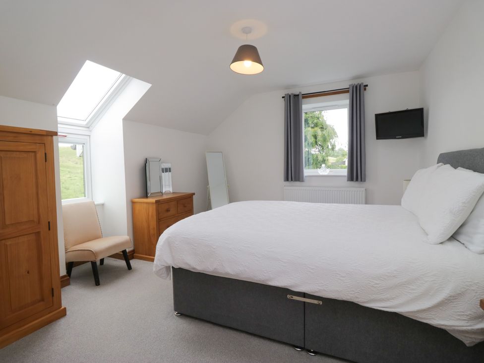 A bedroom with a bed and a television at Sherriff in Troutbeck, near Keswick