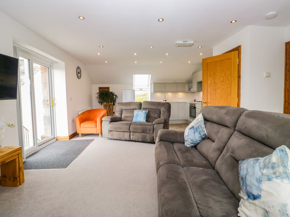 A living room with sofas and an armchair at Sherriff, Troutbeck near Keswick