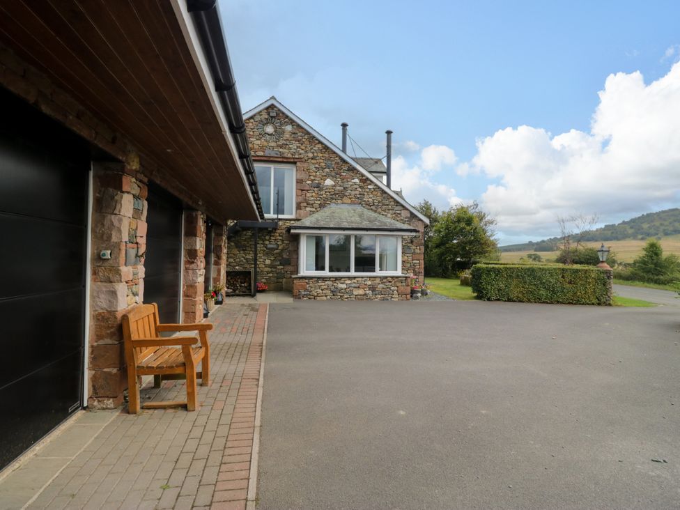 A house with a garage and bench in the outdoor area at Sherriff, Troutbeck, near Keswick