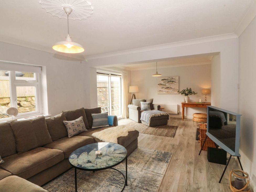 A living room with a sofa and coffee table at Afallon in Llanbedrog