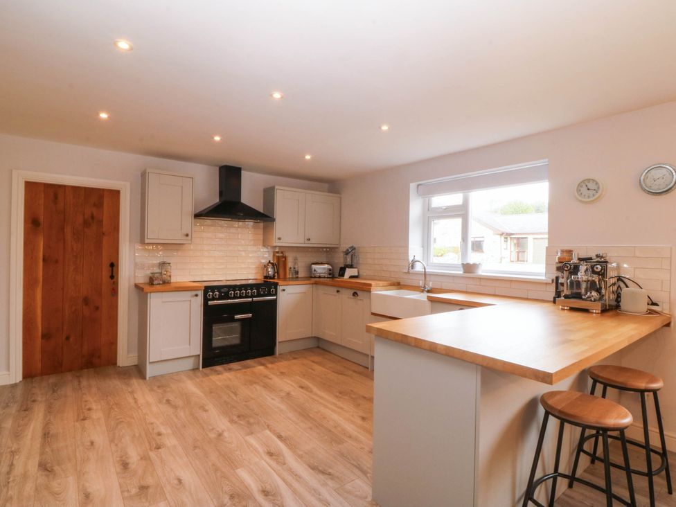 A kitchen with cabinets and countertop at Afallon in Llanbedrog