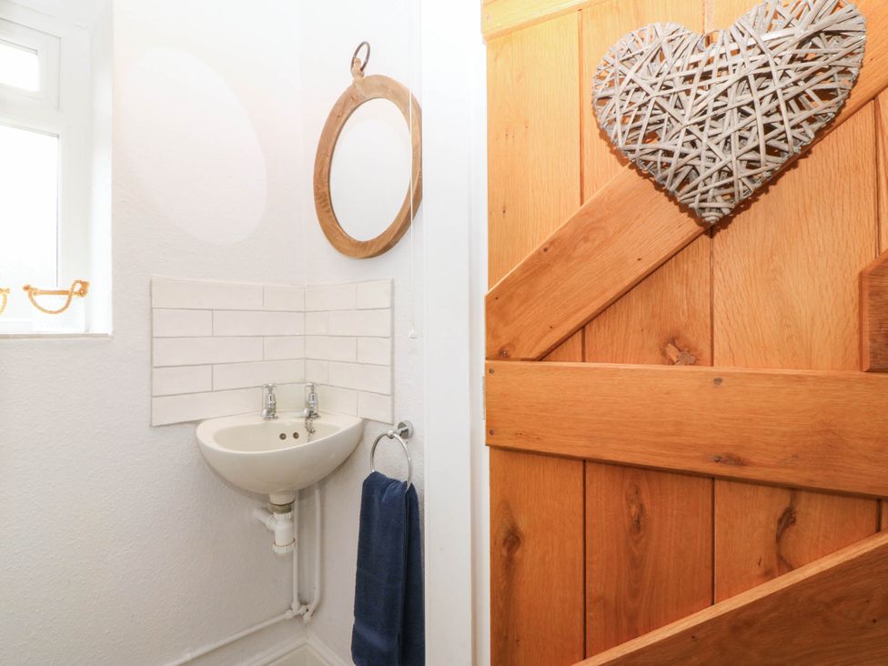 A bathroom with a sink and mirror at Afallon in Llanbedrog