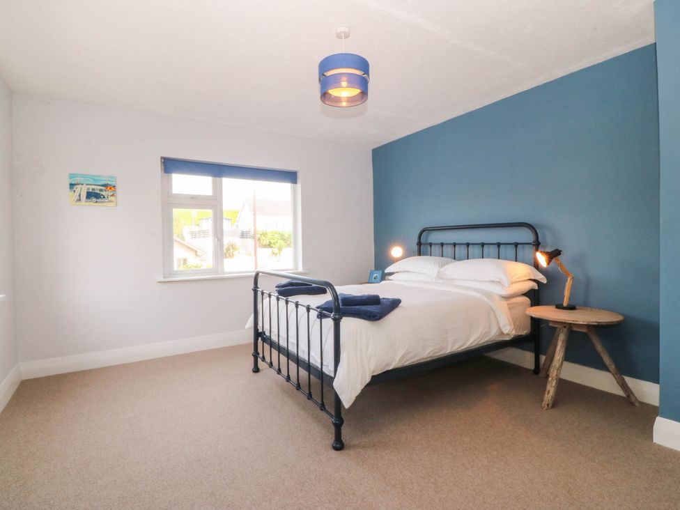 A bedroom with a bed and table at Afallon in Llanbedrog
