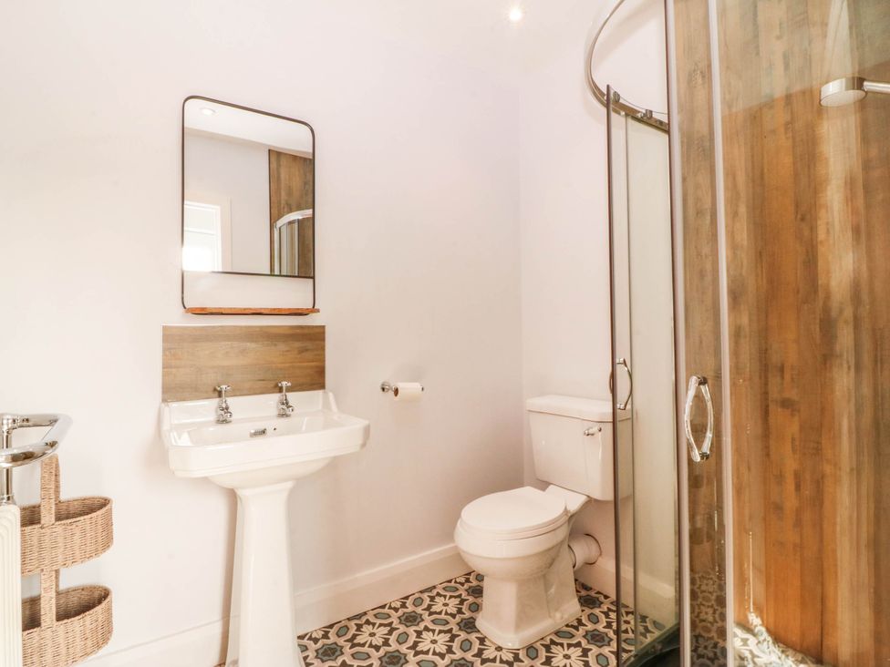 A bathroom with a sink and shower at Afallon in Llanbedrog