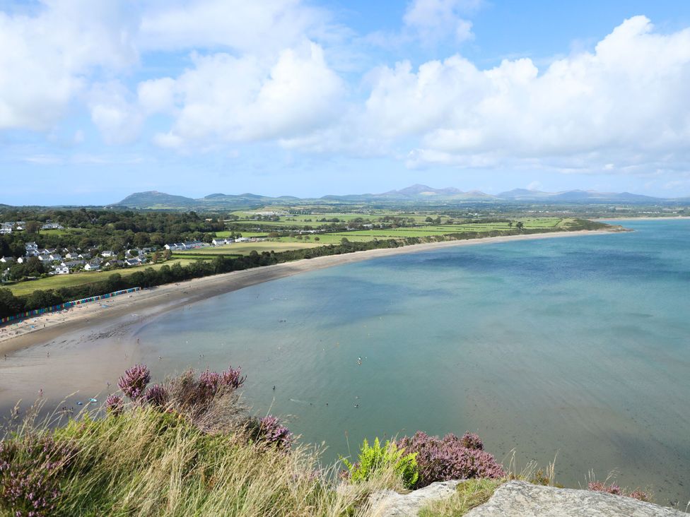 A coastline view with water and hills at Afallon in Llanbedrog