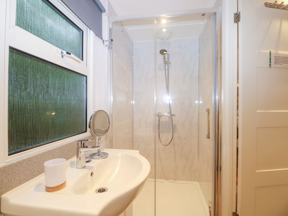 A bathroom with a shower and sink at Orchard Lodge Bolney