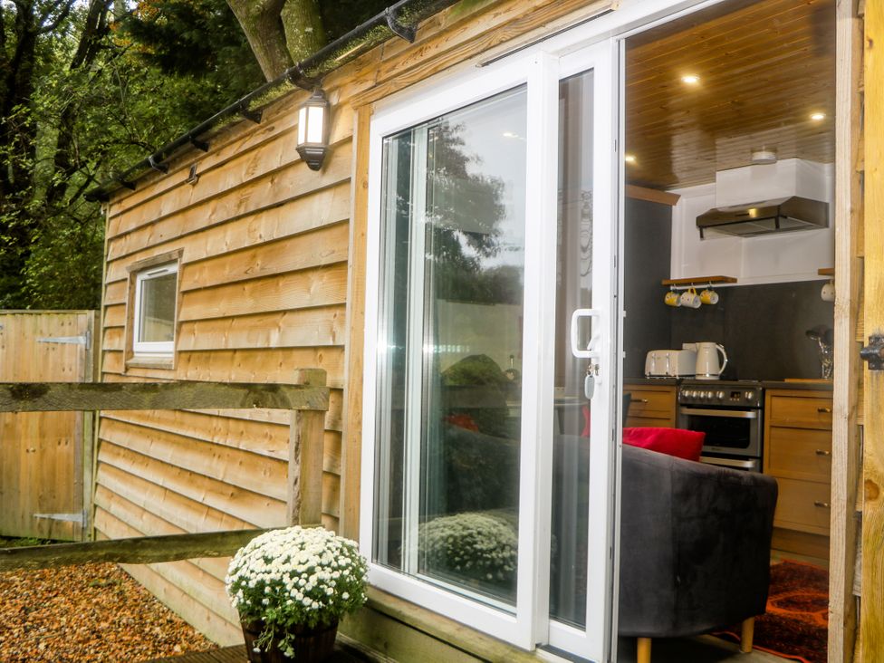A kitchen with appliances viewable from outside at Harvest Lodge in Wineham near Bolney