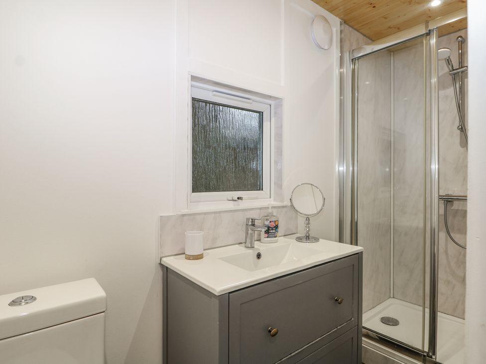 A bathroom with a sink and shower at Harvest Lodge Wineham near Bolney