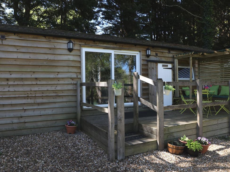 An outdoor seating area with plants at Harvest Lodge in Wineham near Bolney
