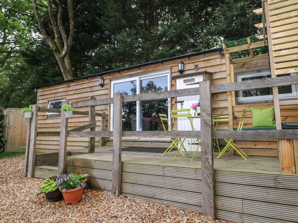 An outdoor area with seating and planters at Harvest Lodge in Wineham near Bolney
