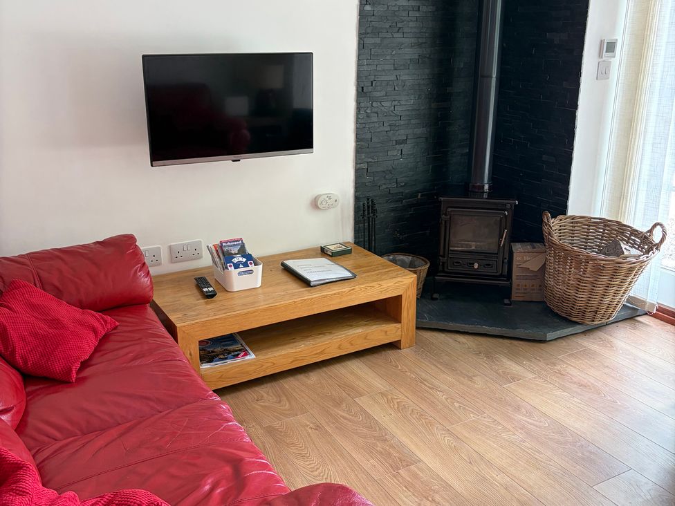 A living room with a sofa and a television at Beechwood Cottage in Easby near Great Ayton