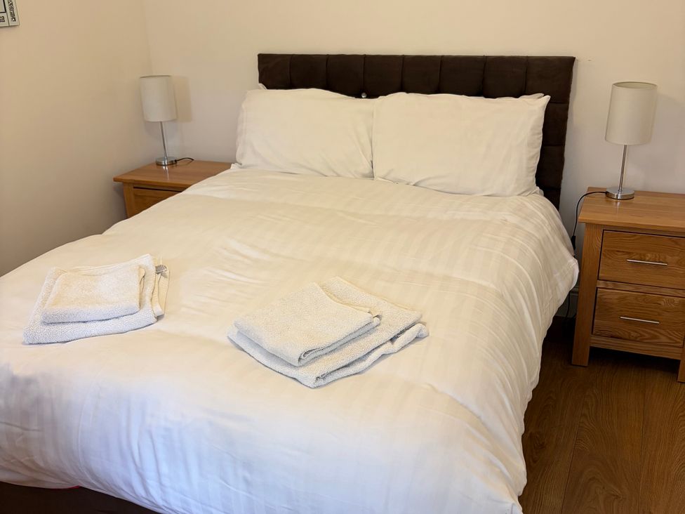A bedroom with a bed and towels at Beechwood Cottage Easby near Great Ayton