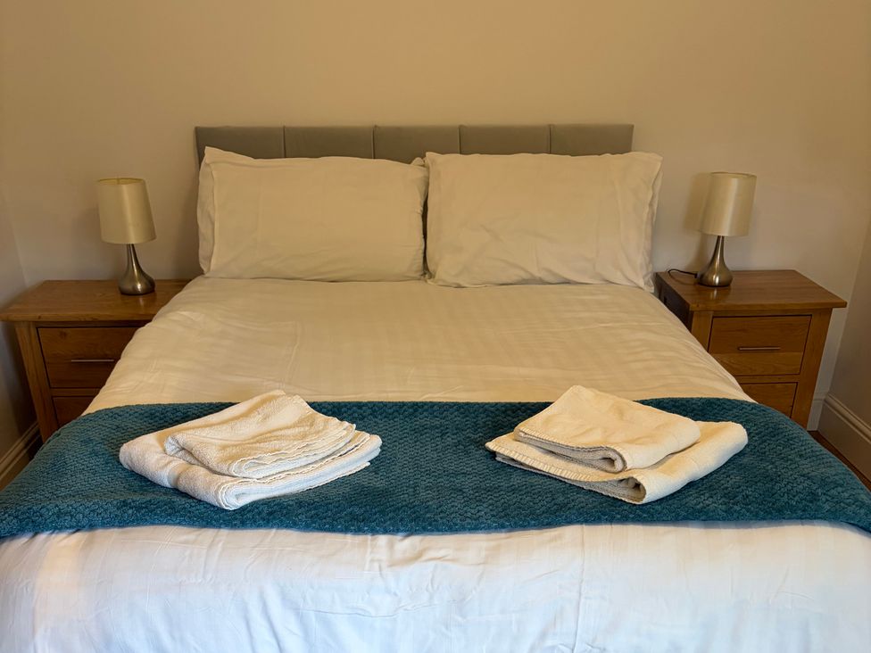 A bedroom with a bed and towels arranged in Beechwood Cottage Easby near Great Ayton