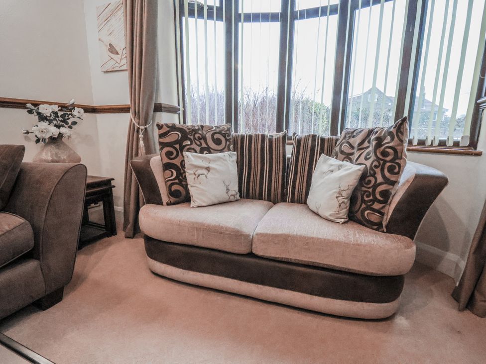 A living room with a sofa and cushions at Beachcrest in Whitby