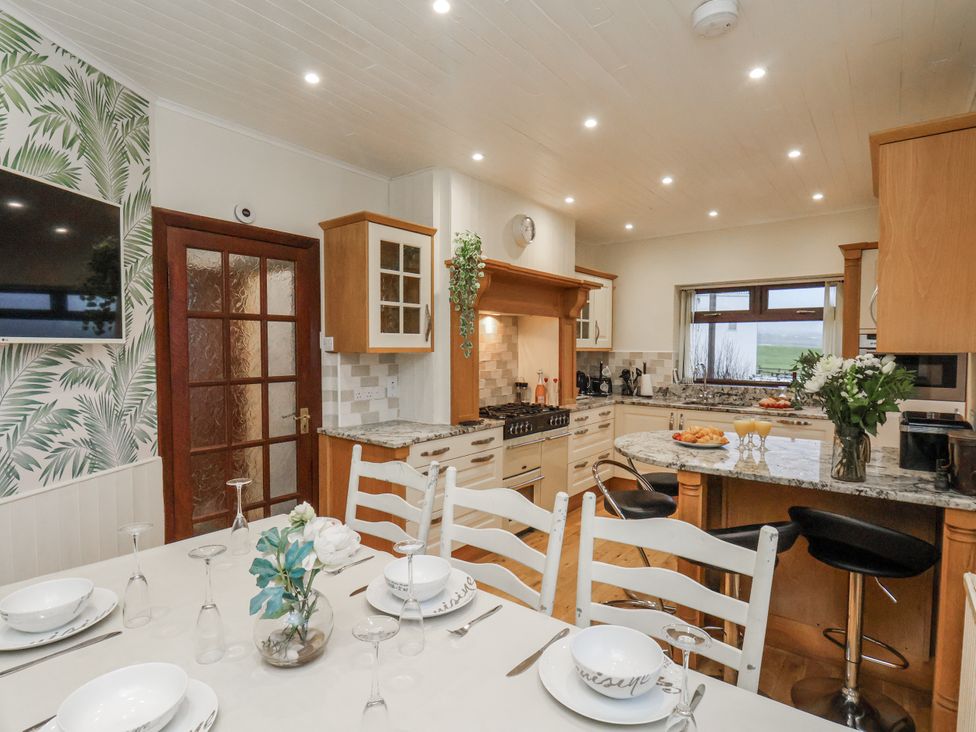 A kitchen with a dining table and chairs at Beachcrest in Whitby