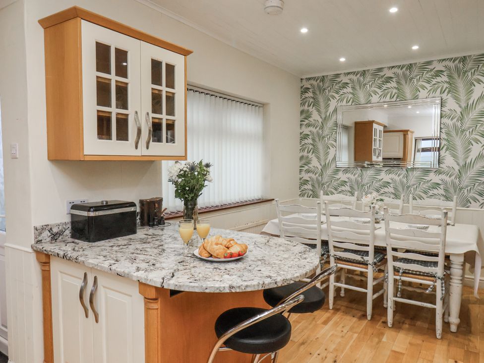 A kitchen with a dining area and food on the table at Beachcrest in Whitby