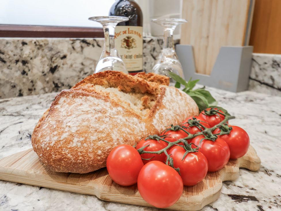 Bread and tomatoes on a cutting board at Beachcrest in Whitby