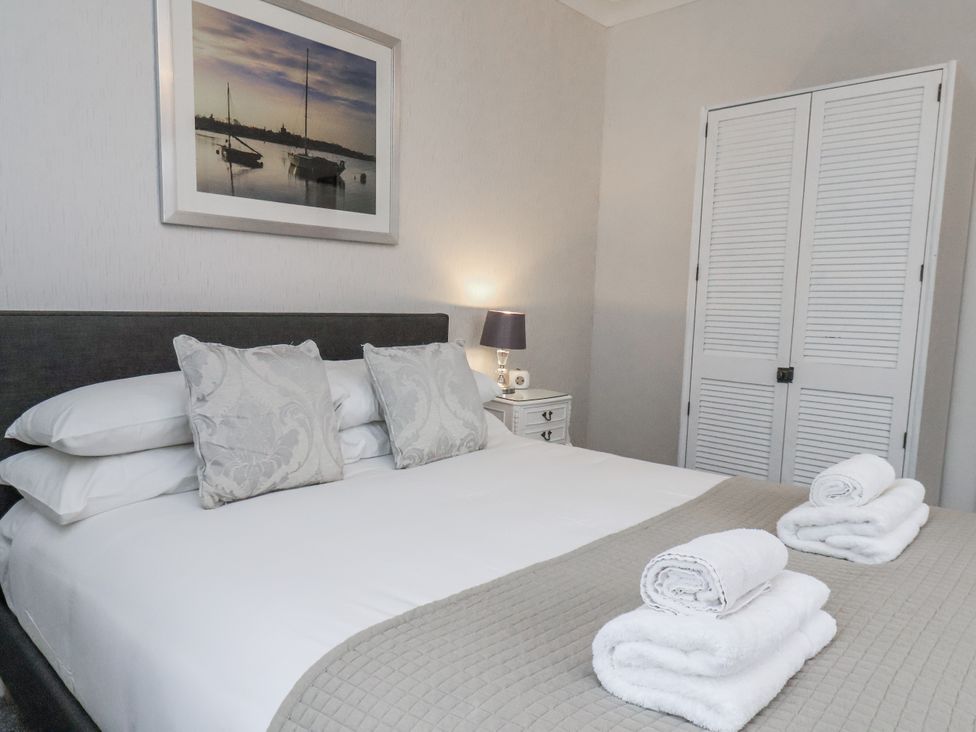 A bedroom with a bed and towels at Beachcrest in Whitby