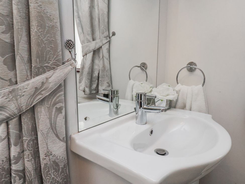 A bathroom with a sink and mirror at Beachcrest in Whitby