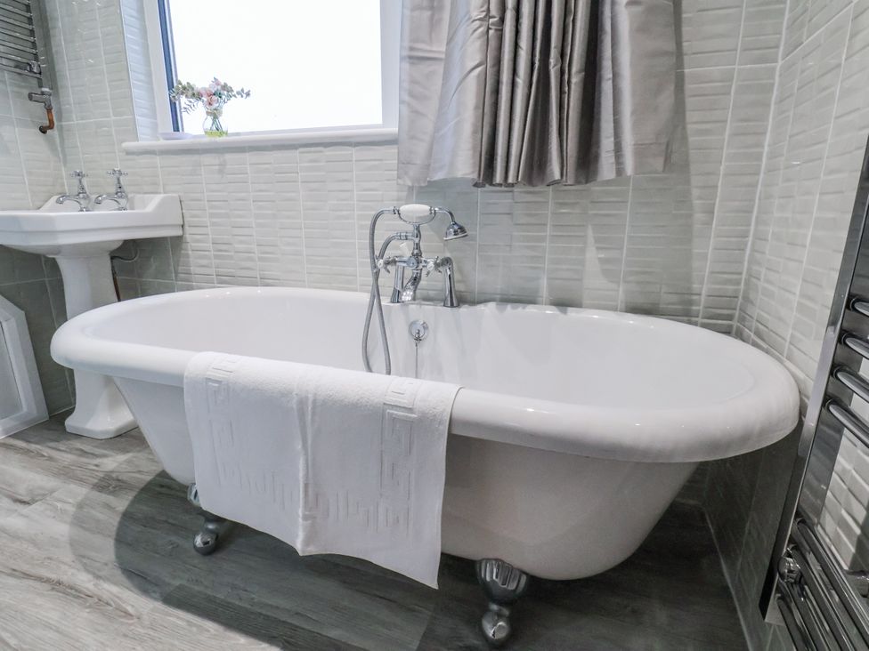A bathroom with a bathtub and sink at Beachcrest in Whitby