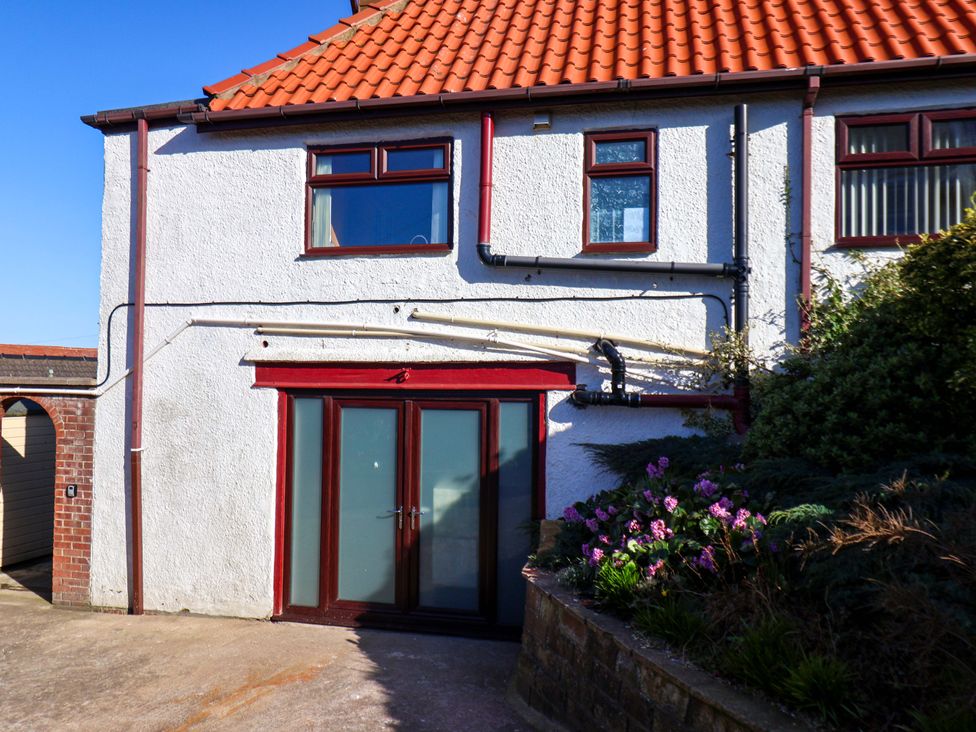 An outdoor view of a house facade with a door and windows at Beachcrest in Whitby