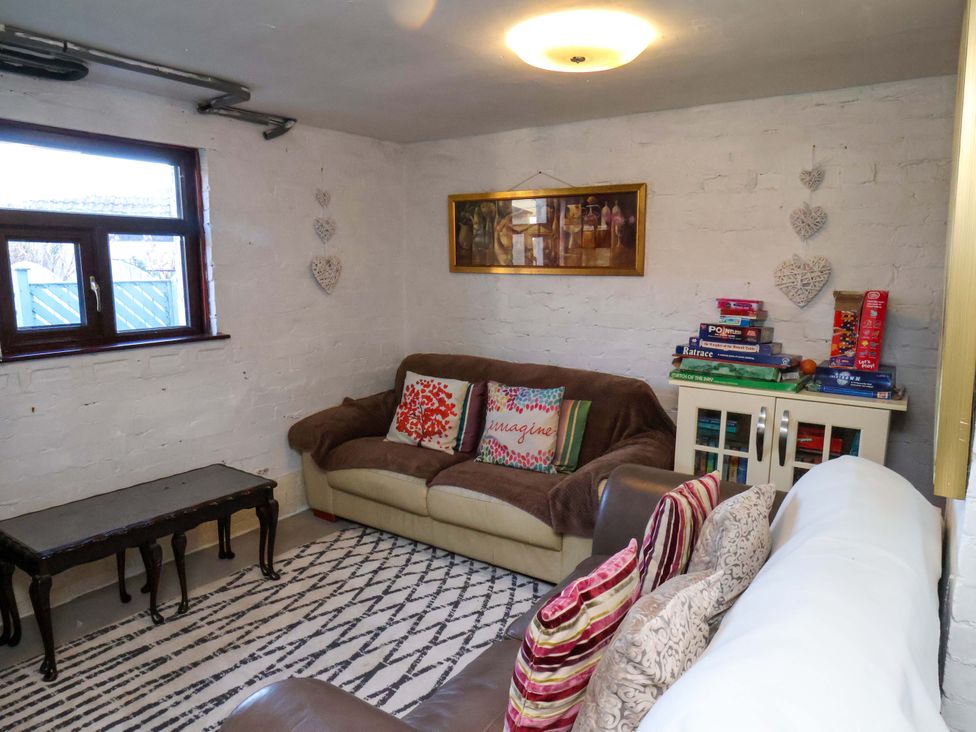 A snug with a sofa and table at Beachcrest in Whitby