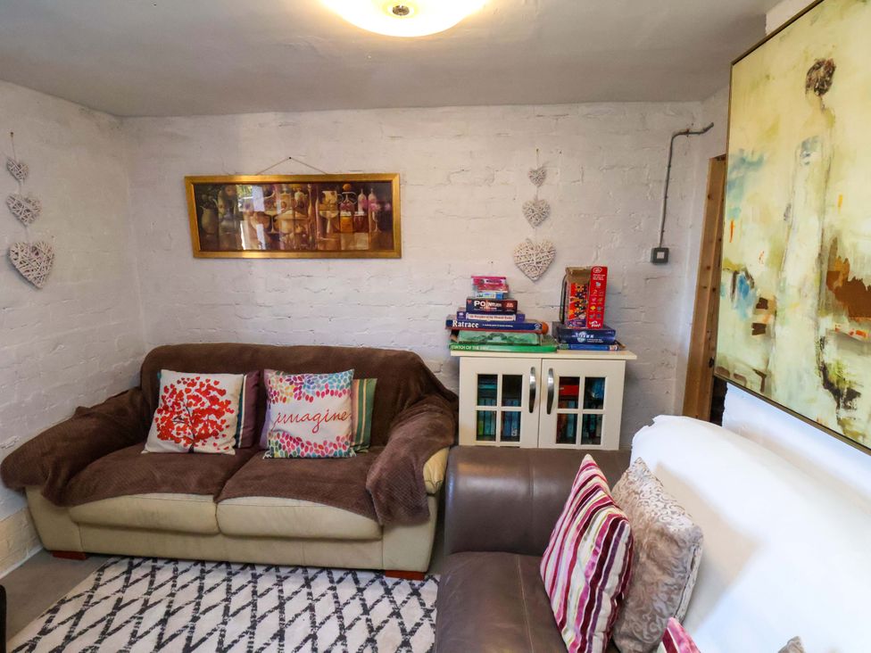 A living room with a sofa, table, and wall art at Beachcrest in Whitby