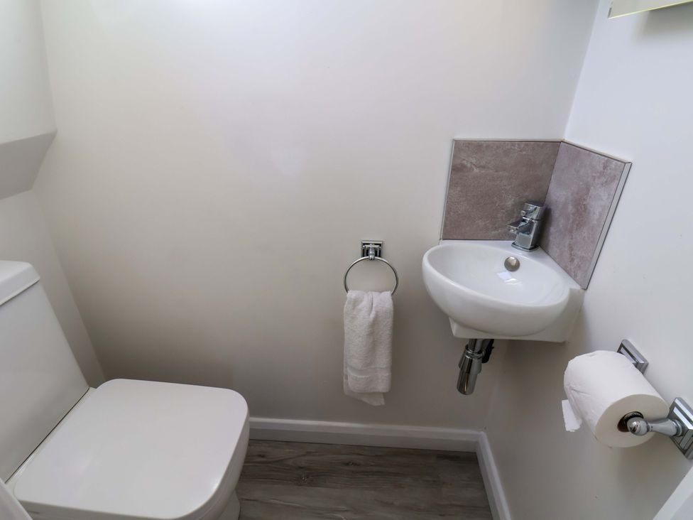A bathroom with a toilet and sink at Beachcrest in Whitby