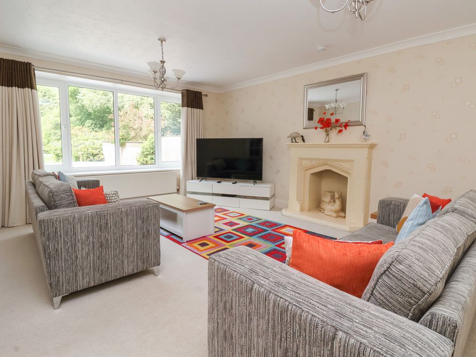 A living room with a television and sofa at Raincliffe Manor in Scarborough