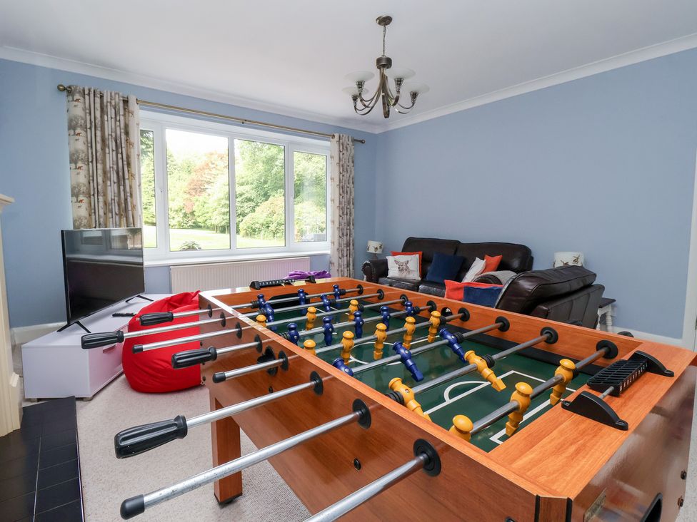 A snug with a foosball table and sofa at Raincliffe Manor in Scarborough