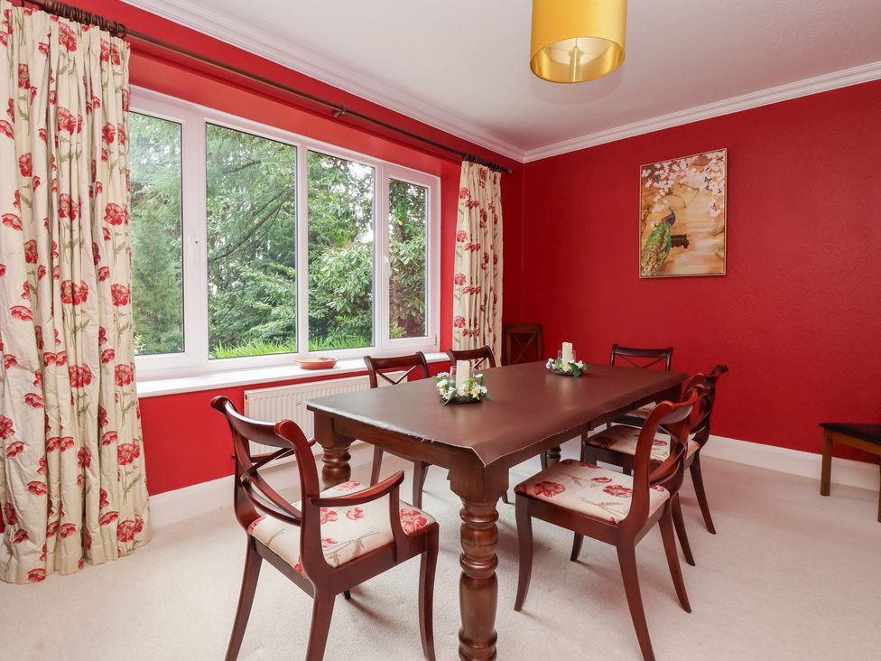A dining room with a wooden table and chairs at Raincliffe Manor in Scarborough