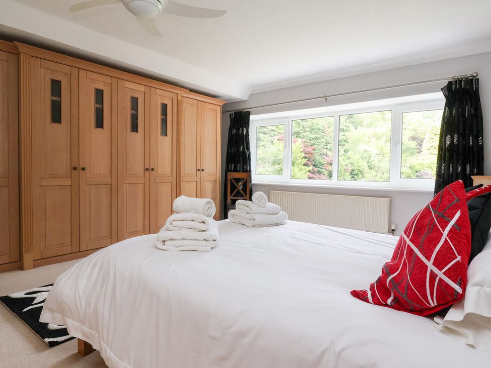 A bedroom with a bed and wardrobe at Raincliffe Manor in Scarborough