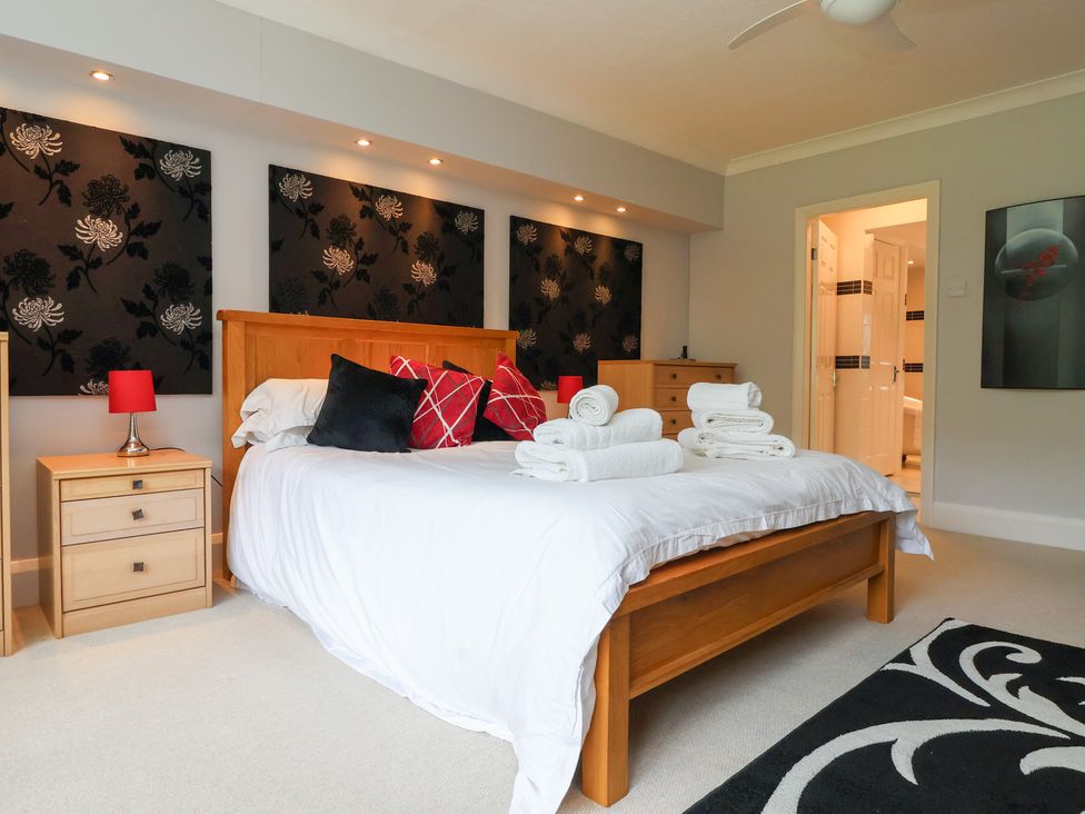 A bedroom with a bed and towels on it at Raincliffe Manor in Scarborough