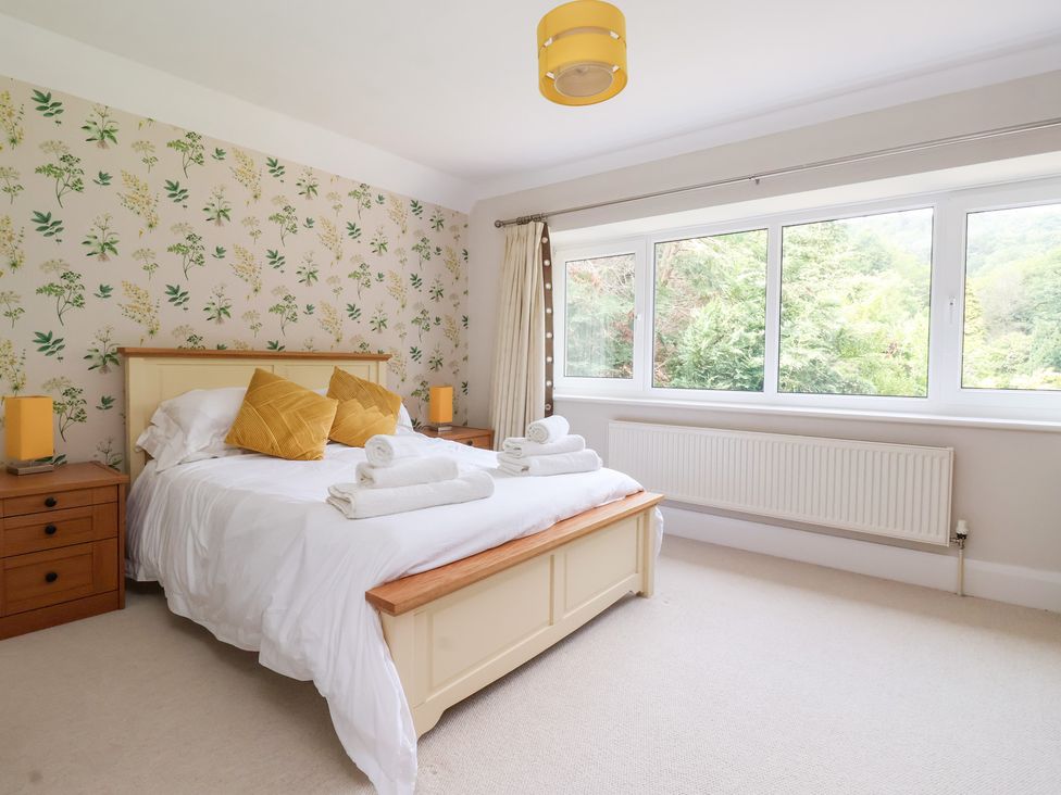 A bedroom with a bed and large windows at Raincliffe Manor in Scarborough
