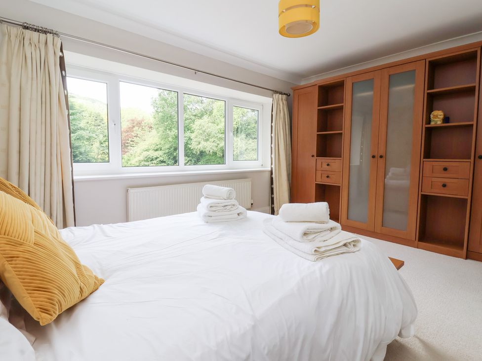 A bedroom with a bed and a wardrobe at Raincliffe Manor in Scarborough
