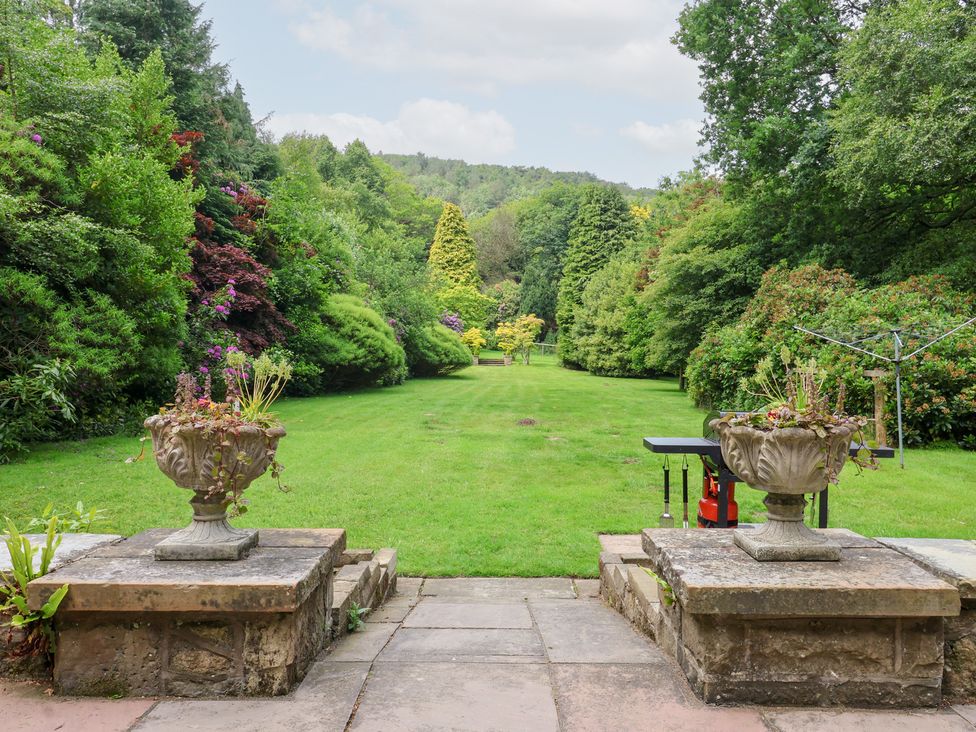 A garden with planters and lawn at Raincliffe Manor in Scarborough