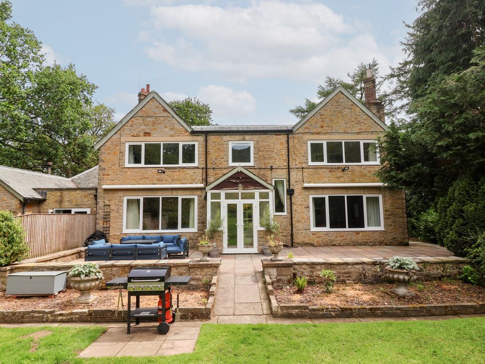 A house with a patio and lawn at Raincliffe Manor in Scarborough