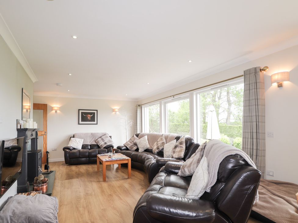 A living room with sofas and a coffee table at Culreach Lodge near Grantown-on-Spey