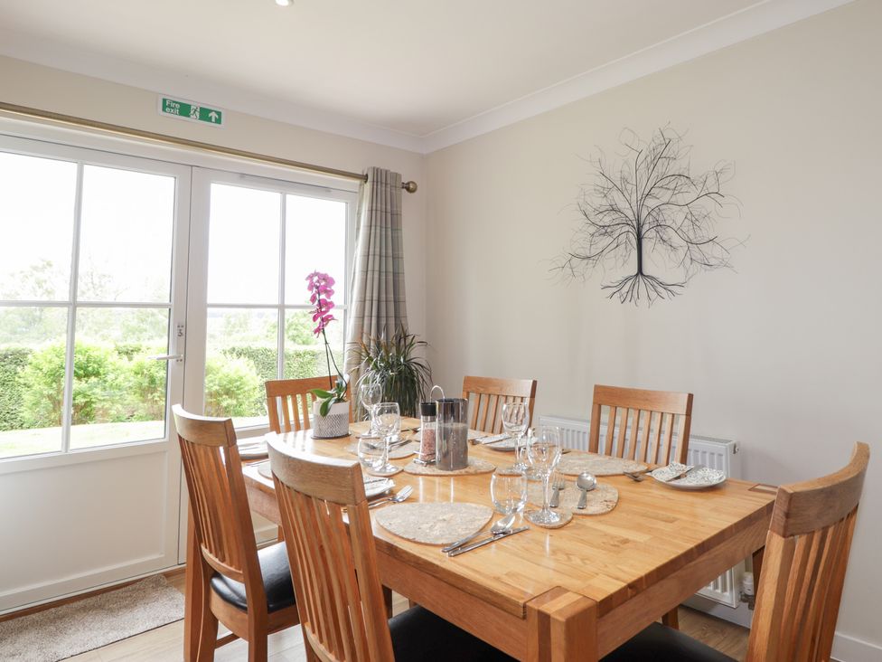 A dining room with a table set for meals at Culreach Lodge Grantown-on-Spey near Nethy Bridge