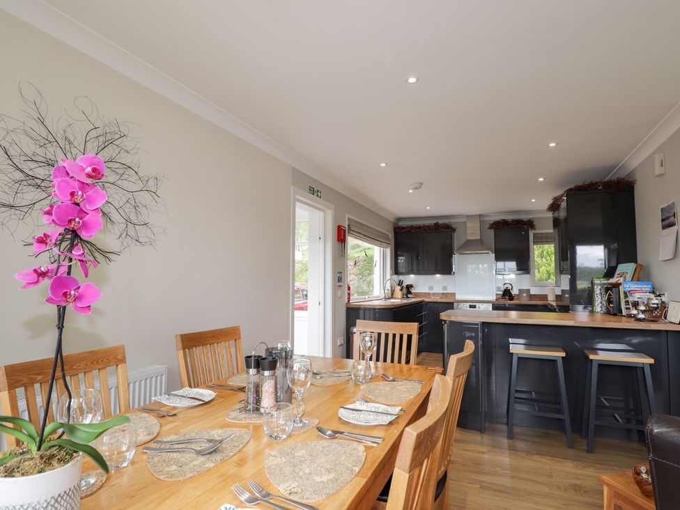 A dining room with a table set for meals at Culreach Lodge Grantown-on-Spey near Nethy Bridge