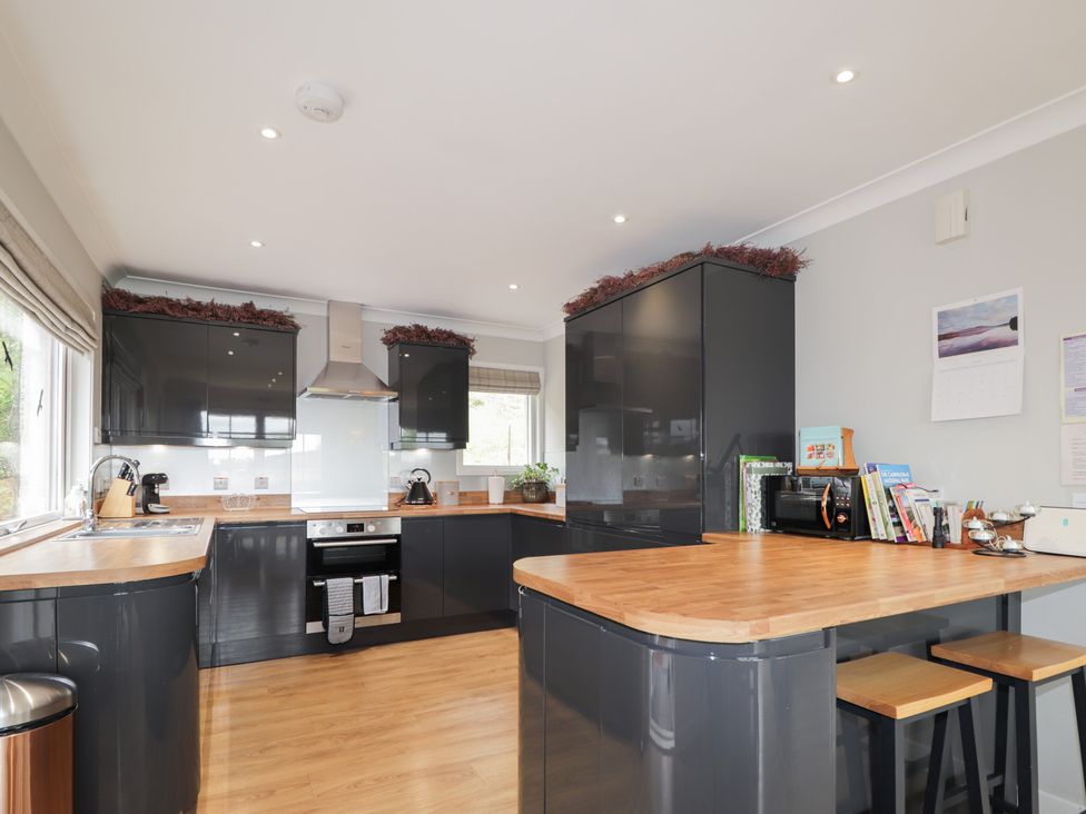 A kitchen with cabinets and appliances at Culreach Lodge in Grantown-on-Spey near Nethy Bridge
