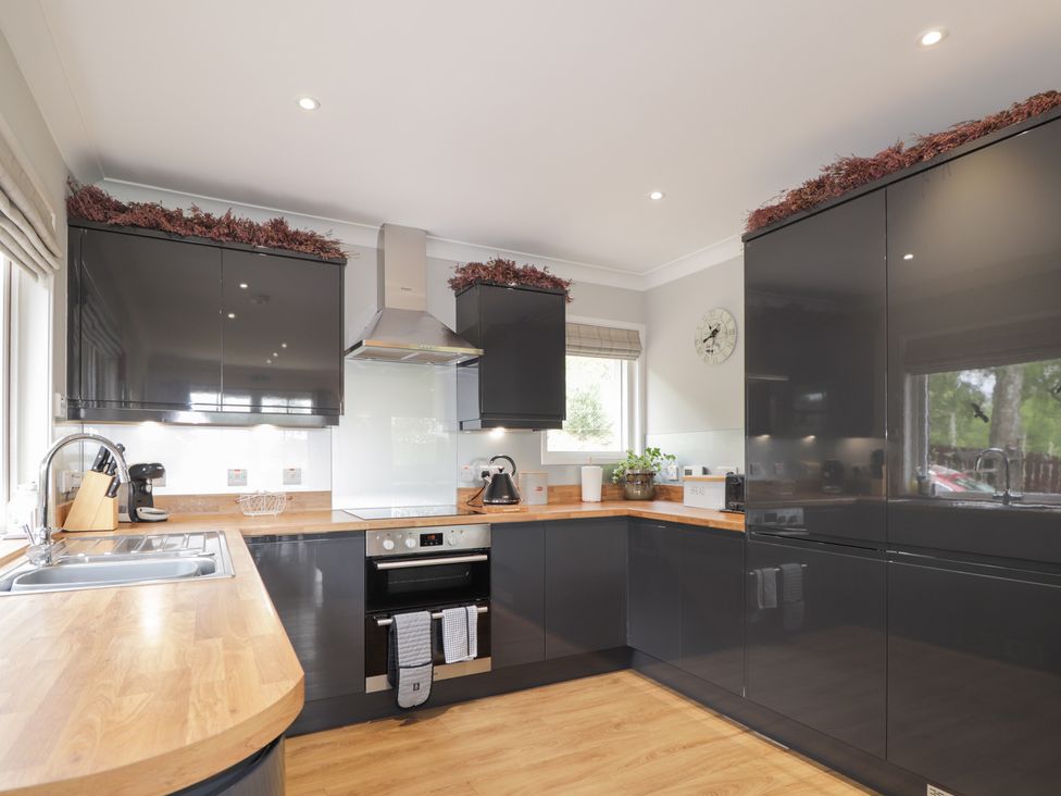 A kitchen with cabinets and an oven at Culreach Lodge in Grantown-on-Spey near Nethy Bridge