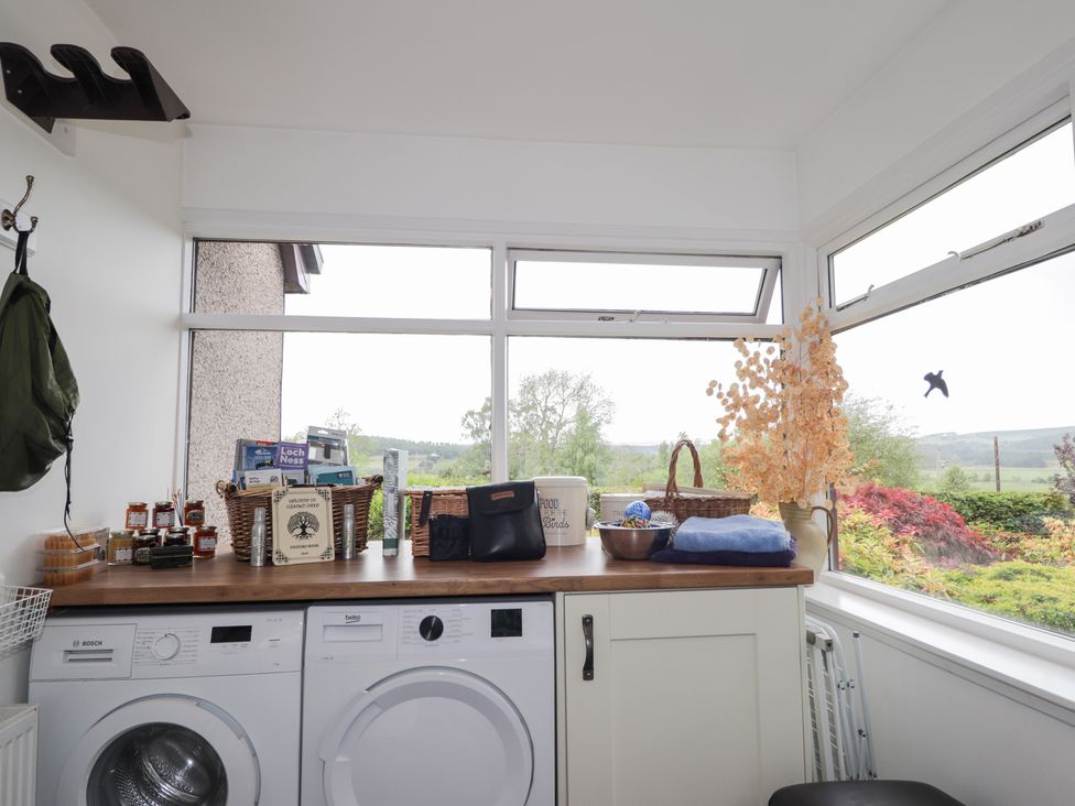 A utility room with washing machine and dryer at Culreach Lodge Grantown-on-Spey near Nethy Bridge