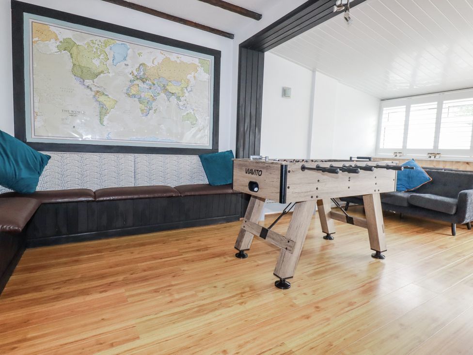 A recreation room with a foosball table and a world map at The Three Tees, Newquay
