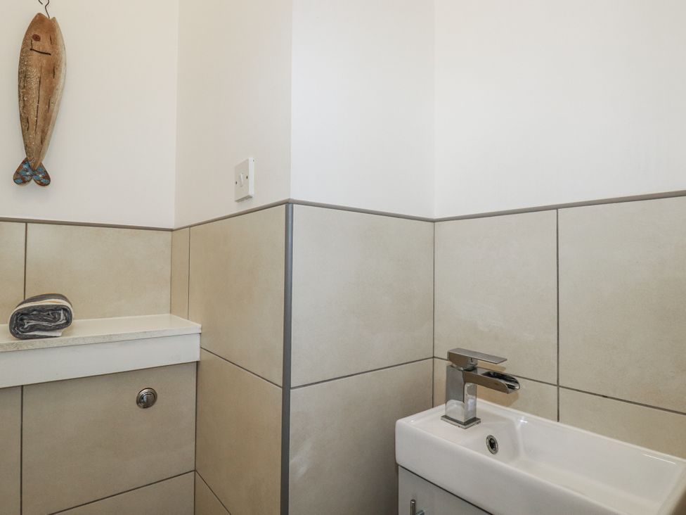 A bathroom with a sink and towel at The Three Tees in Newquay